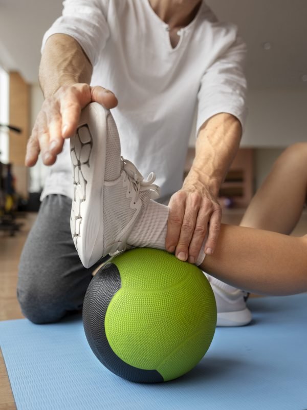 patient-doing-physical-rehabilitation-helped-by-therapists